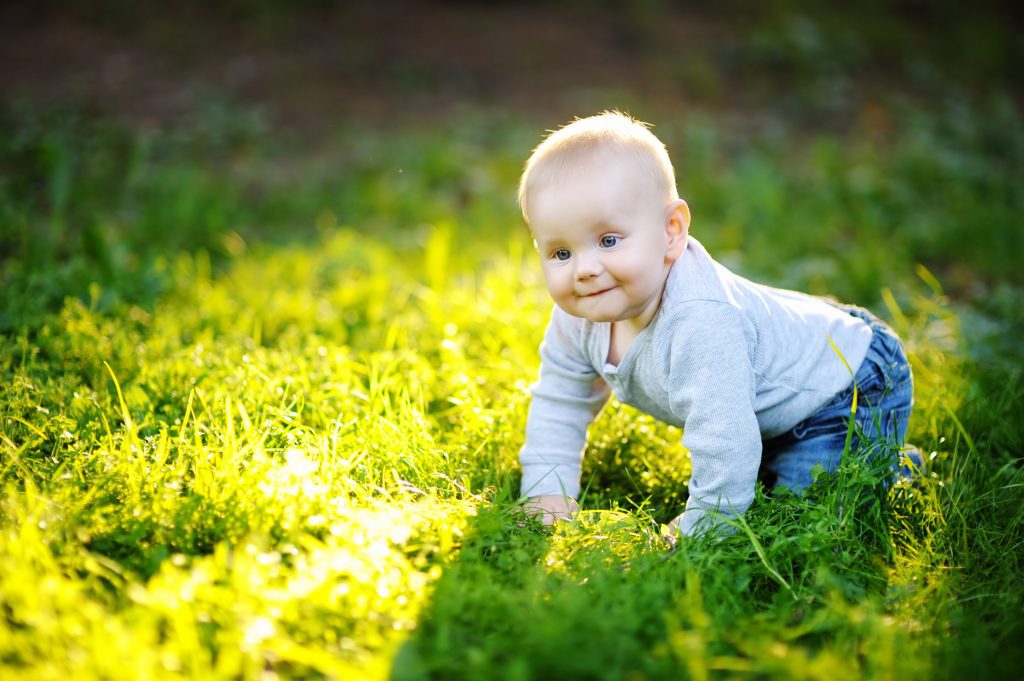 Little baby boy at the sunny park