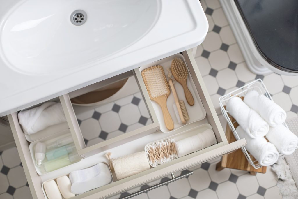 Marie Kondo's method organization of bathroom amenities. Tidying up or storage household space