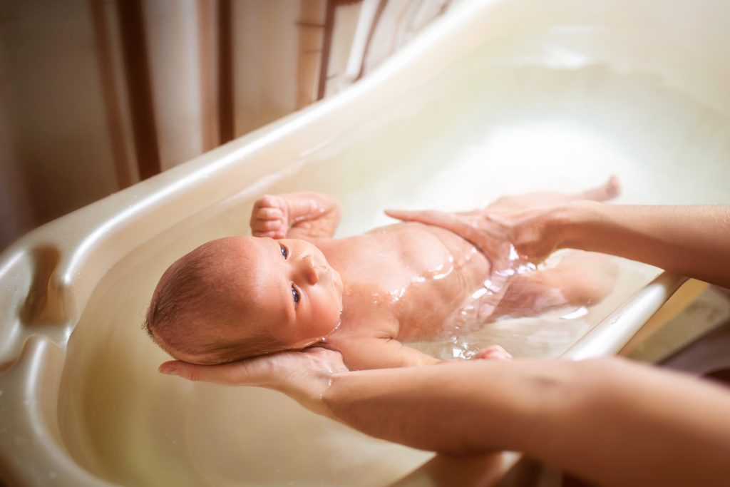 Small cute big eyed beautiful baby bathes