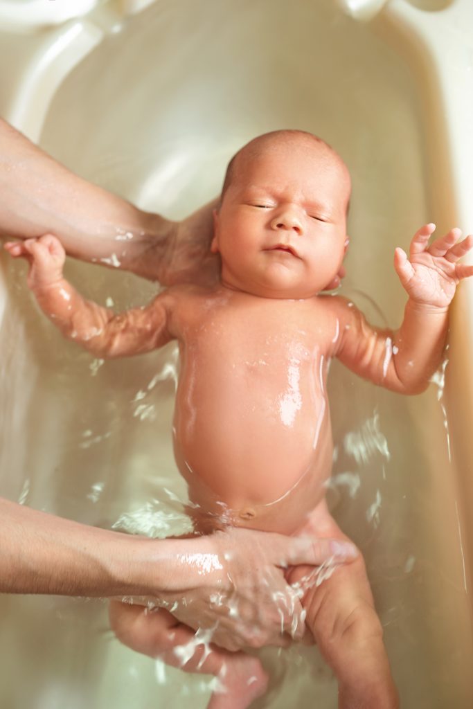Small cute big eyed beautiful baby bathes