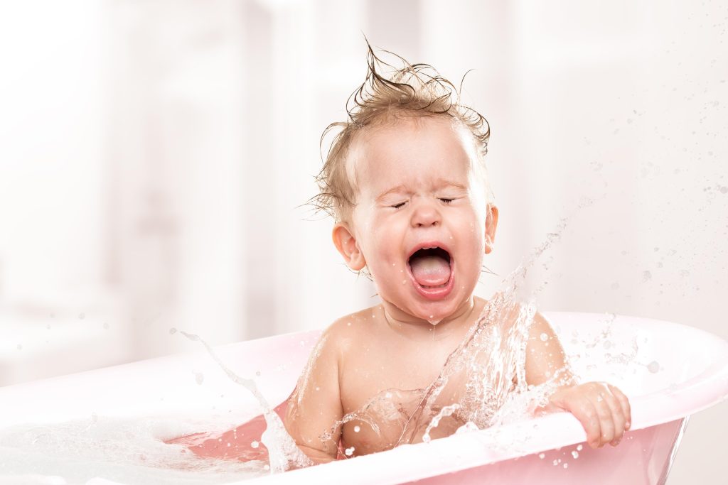 happy funny baby laughing and bathed in the bath