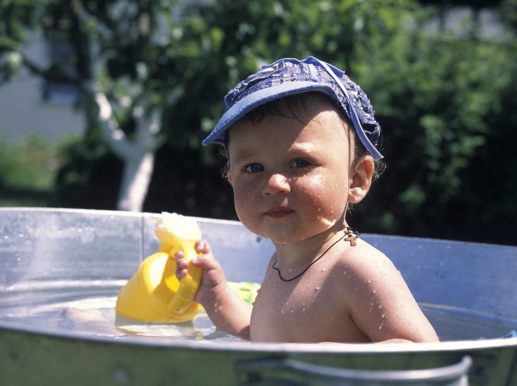 Beautiful baby boy in child tub posing photographer