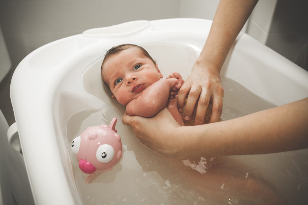 First bath of newborn baby girl.